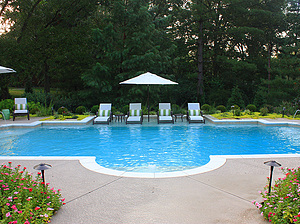 st. louis custom designed grecian concrete pool with federal stone coping and large tan shelf with lounge chairs
