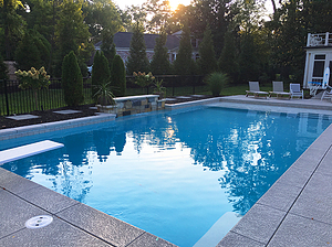 st. louis custom designed geometric concrete pool with cantilever coping, jump board and raised wall with sheer descent